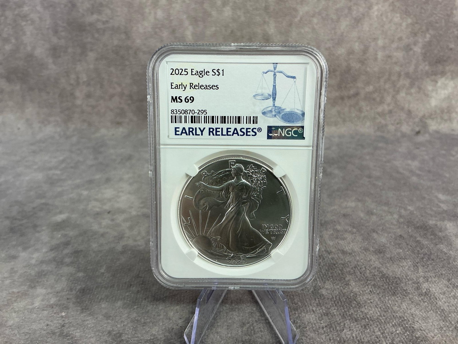 2025 Silver Eagle: 2025 American Silver Eagle, MS 69, graded by NGC. Certification number 8350870-295. Measures 2.25 inches wide x 3.25 inches tall.