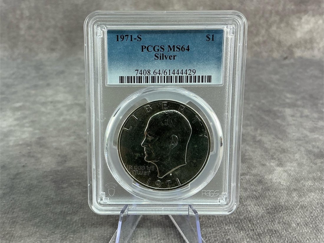 Ike Dollar: 1971S Eisenhower Silver Dollar, MS 64, graded by PCGS. Certification number 7408.64/61444429. Measures 2.25 inches wide x 3.25 inches tall.