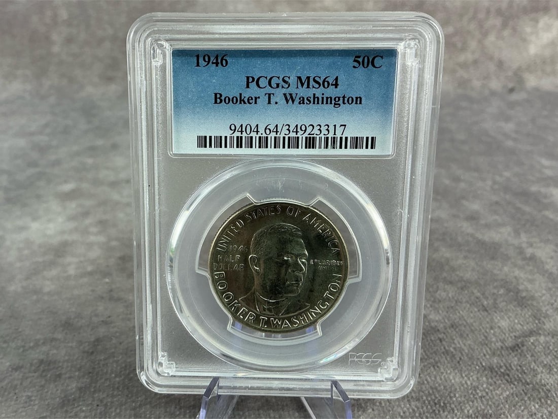 Booker T. Half Dollar: 1946 Booker T. Washington commemorative silver half dollar, MS64, graded by PCGS. Certification number 9404.64/34923317. Measures 2.25 inches wide x 3.25 inches tall.