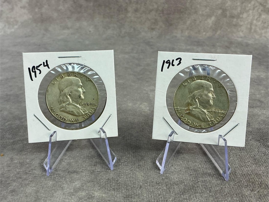 Franklin Halves: 1954 and 1963 Franklin Half Dollars, 90% silver. Both in good circulated condition with protective cardboard holder. Total weight 0.92 ozt.