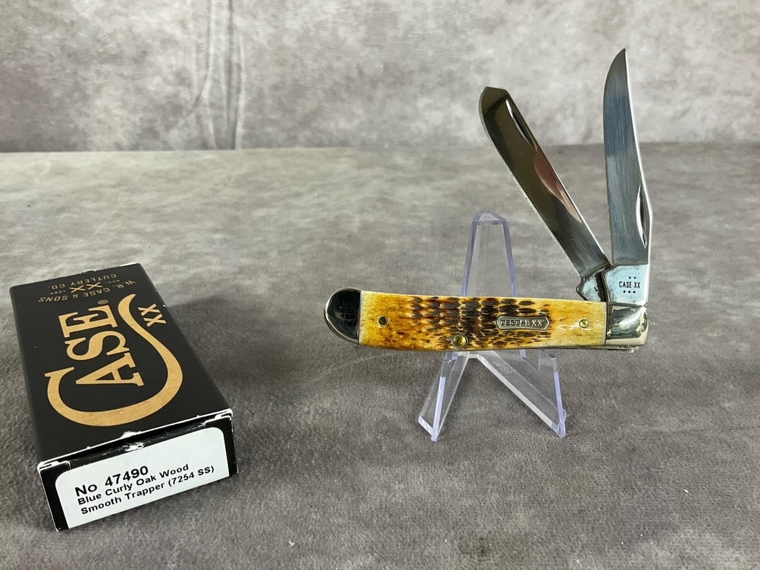 Jigged Burnt Amber Bone Knife: Case XX Mini Trapper 6207. Tight snap, includes box, but not correct. Box measures 4.5 inches wide X 1.75 inches tall.