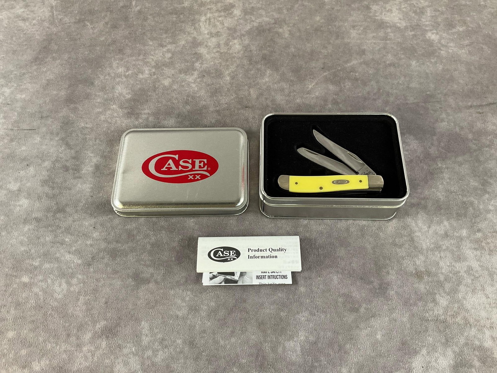 Smooth Yellow Synthetic Knife: Case XX Mini Trapper 3207 cv. Tight snap, includes tin, but not correct. Tin measures 5 inches long X 3.5 inches wide X 1.75 inches high.