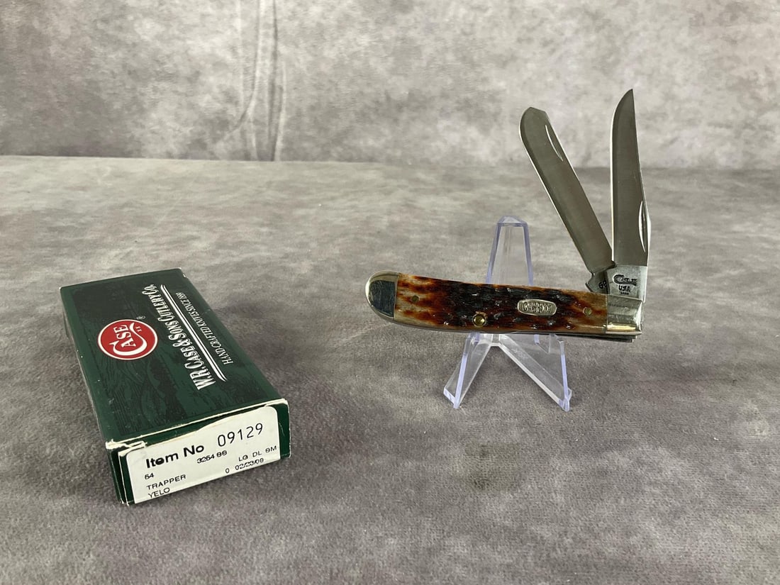 Jigged Amber Bone Knife: Case XX Mini Trapper 6207 SS Tight snap, includes box, not correct. Box measures 4.5 inches wide X 1.75 inches tall.