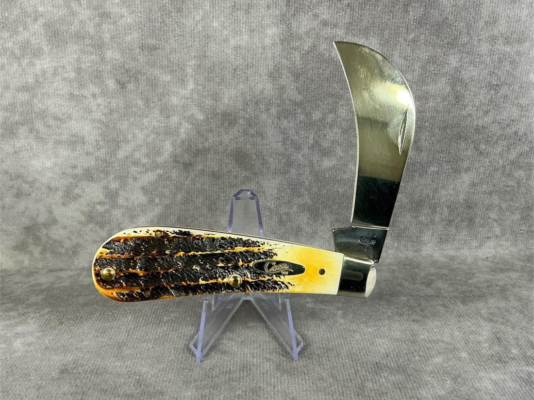 Jigged Bone Hawkbill Knife: 2006 Case XX Hawkbill Pruner pocketknife with burnt bonestag handle, 6.51011 SS. Tight snap, good condition. Measures 4 inches long closed.