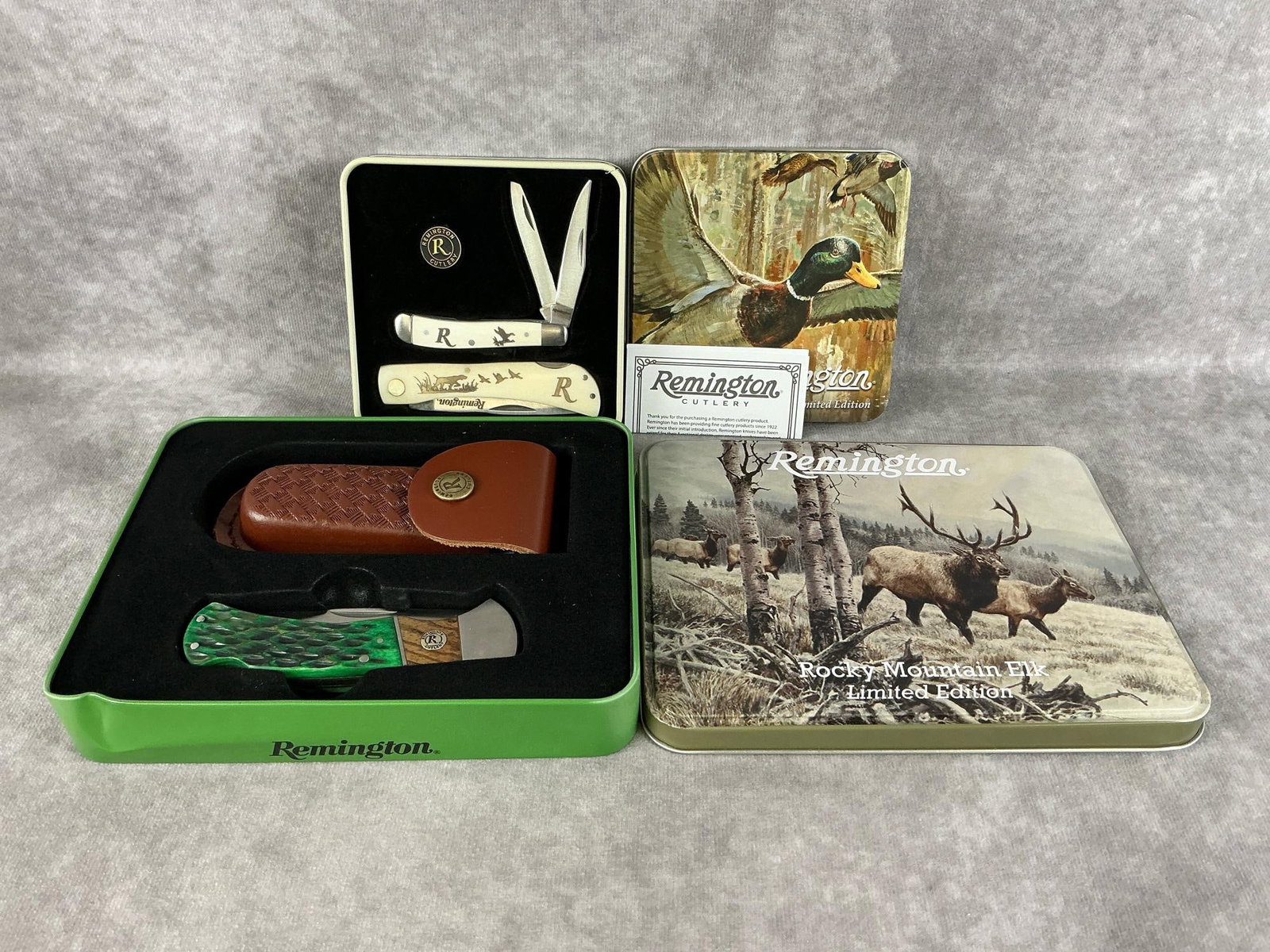 Remington Knives: Two modern gift sets made by Remington in their original tins. One Whitetails & Fox and one Mallards in the Timber. Both in good condition. Largest tin measures 7 inches wide x 1.25 x 5.5 inches tall.