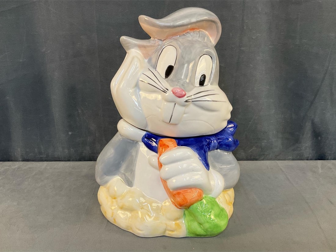 Bygs Bunny Cookie Jar: 1999 Looney Tunes Bugs Bunny ceramic cookie jar by Gibson. Good condition. Measures 8 inches wide x 9.5 x 11.5 inches tall.