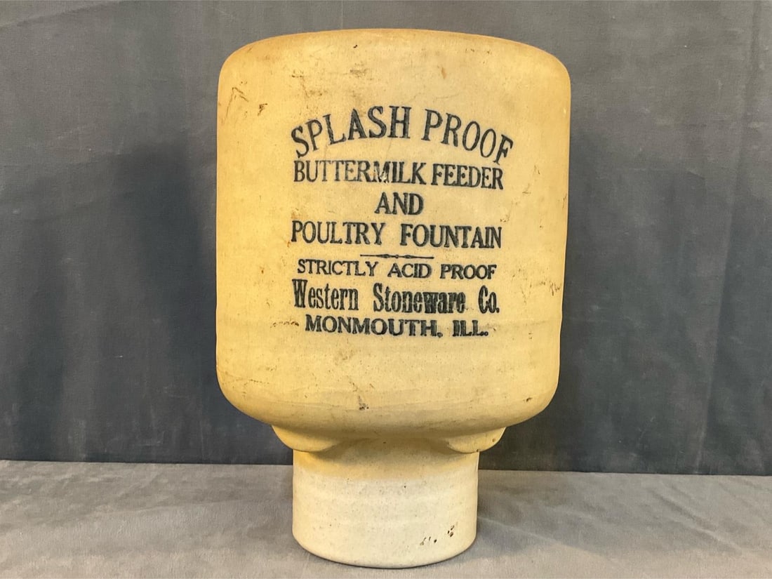 Stoneware Poultry Feeder: Early 20th century unglazed stoneware poultry feeder marked, "SPLASH PROOF / BUTTERMILK FEEDER / AND / POULTRY FOUNTAIN / STRICTLY ACID PROOF / Western Stoneware Co. / MONMOUTH, ILL.". Missing base,