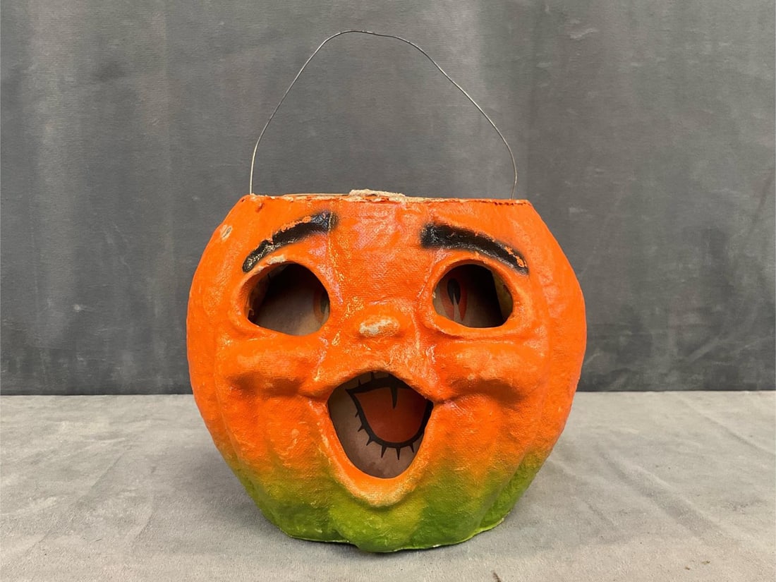 Jack-o'-Lantern Pail: 1940's-1950's molded pulp paper mache "Choir Boy" Jack-o'-Lantern candy pail with paper face insert and wire bail handle. Original battery and light holder inside pail with green cardboard operating
