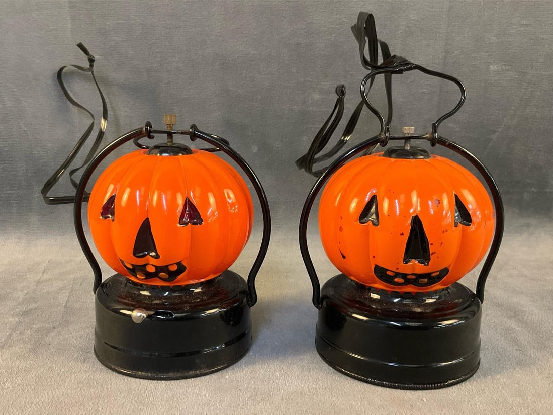 Glass Jack-o'-Lanterns: Two circa 1960 battery operated Halloween pumpkin glass lanterns marked with pigeon and "AAA / Trade Mark / Made In Japan" on bottom. One with minor area of surface corrosion to bottom and both with