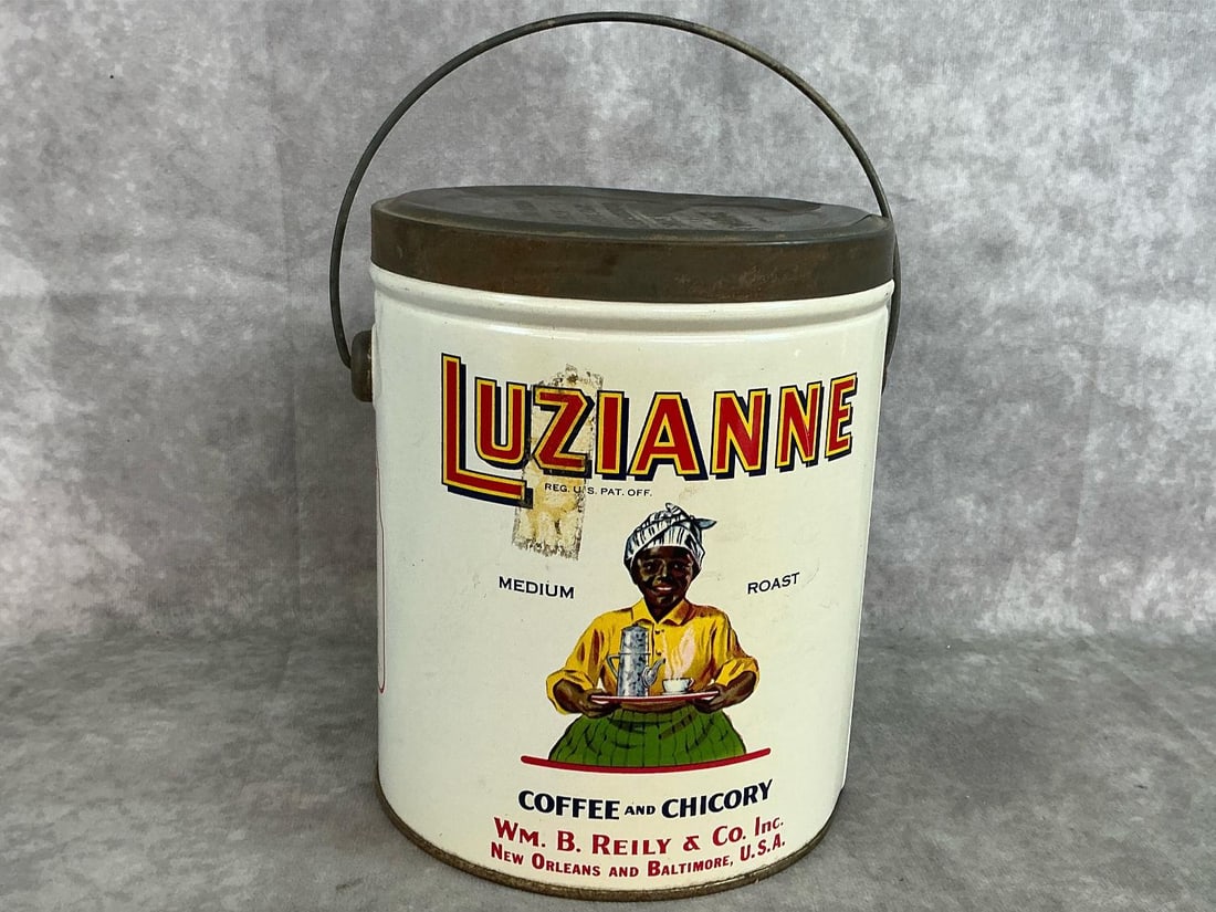 Antique Luzianne Coffee Can: 1928 Luzianne Coffee & Chicory 3 pound can with bail handle. Made by WM B Reilly & Co., New Orleans. Slight rust, otherwise in good condition. Measures 6 inches in diameter x 7.5 inches tall.