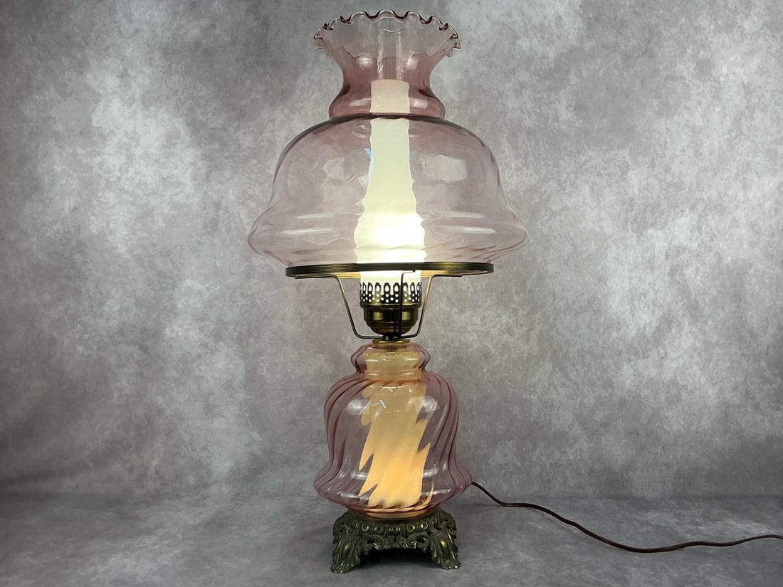 Hurricane Lamp: Late modern Accurate Casting Company Gone With the Wind style pink swirl three way electric hurricane lamp. Tested and in good condition. Measurements are 25 inches tall x 14 inches long.