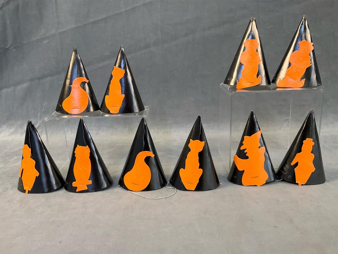 Halloween Hats: Ten assorted 1950's - 1960's children's die cut cardboard black and orange Halloween party hats with rubber band neck straps. Includes owls, cats, pumpkins and scarecrows. Good condition. Measures
