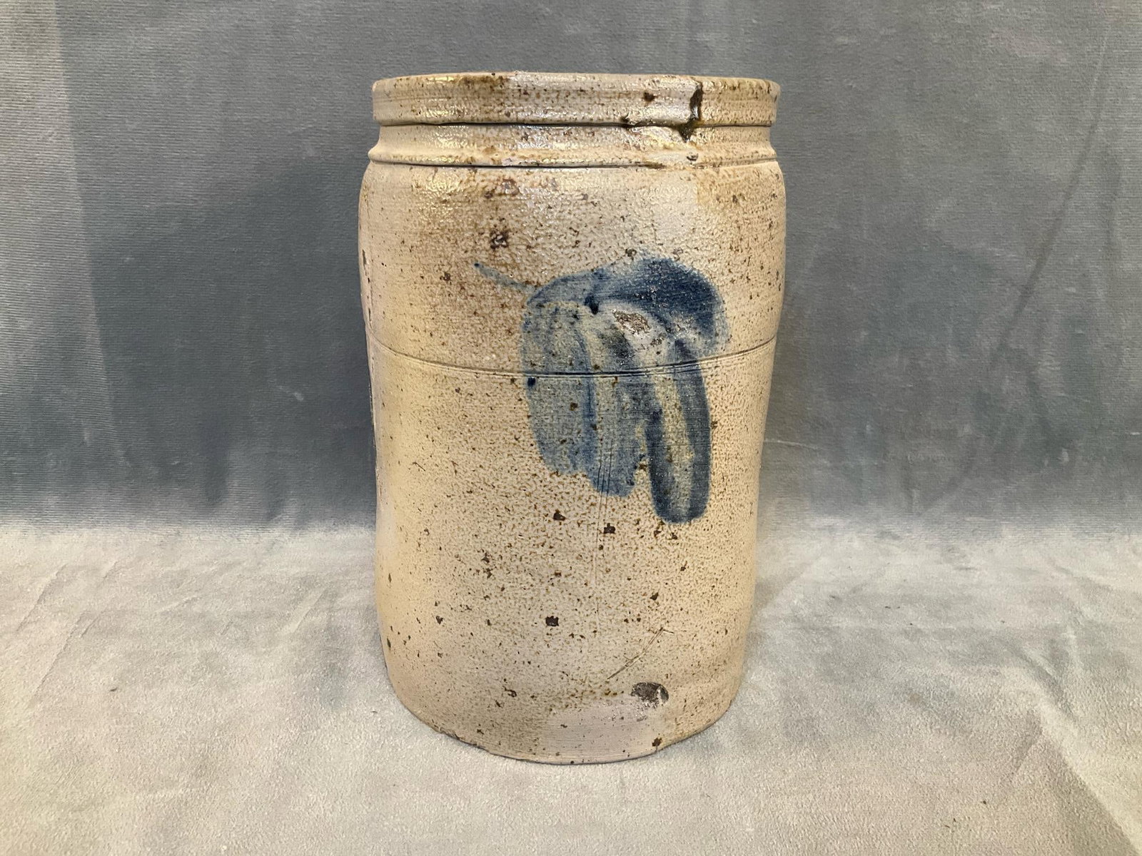 Stoneware Crock: Circa 1870's salt glazed stoneware crock/jar with cobalt decoration. Attributed to Baltimore, Maryland. Small chip to rim and base with kiln flaws, otherwise good condition. Measures 5.5 inches in