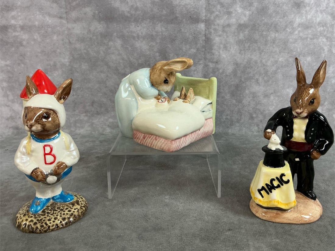 Bunnykins Collectible Figurines: Three 1982-1994 Royal Doulton porcelain figurines. All handpainted and numbered. Set includes "Peter in Bed" Beatrix Potter Bunnykin, "Rocket Man" Astro Bunnykin and "Magician" Bunnykin. All in good