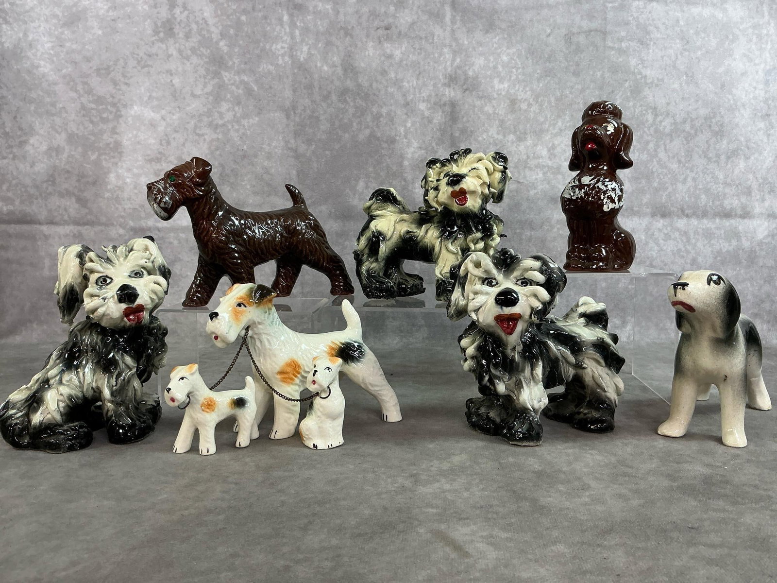 Collectible Ceramic Dogs: Seven mid 1900's ceramic dogs. Three M&R Italian ceramic "fluffy" black and white terriers, Redware poodle, and black and white puppy. Includes brown terrier from Japan and white with spots terrier