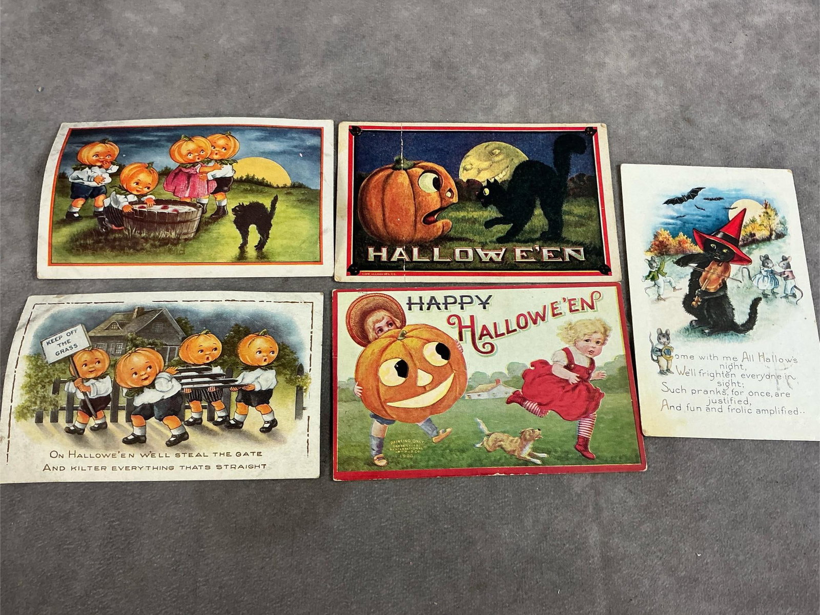 Vintage Halloween Cards: Five early 1900's Halloween postcards. Includes pumpkin children, and black cats. Three are postmarked. In good condition. Measures 5.5 inches wide x 3.5 inches tall.