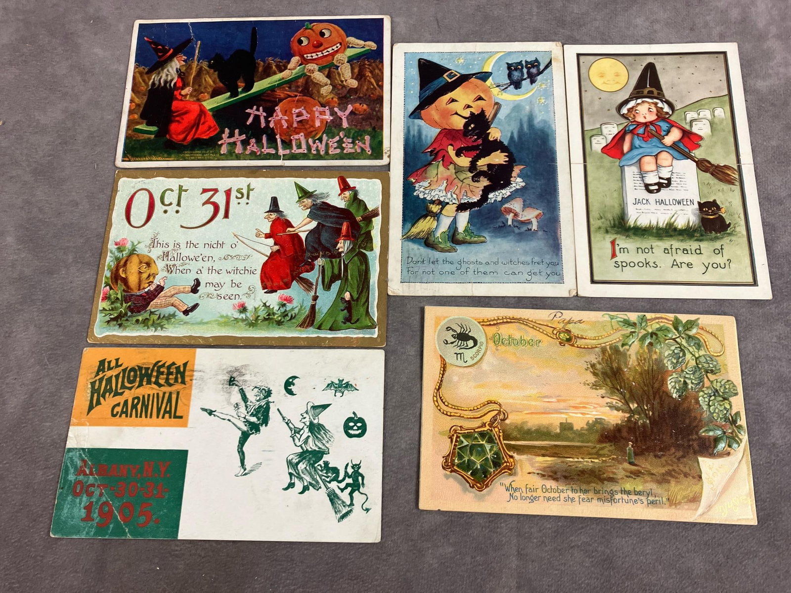 Halloween & October Postcards: Five early 1900's Halloween postcards and an October card. Witches and pumpkins. October card is rural scene. Postmarked on back. In good condition. Measures 5.5 inches wide by 3.5 inches tall.