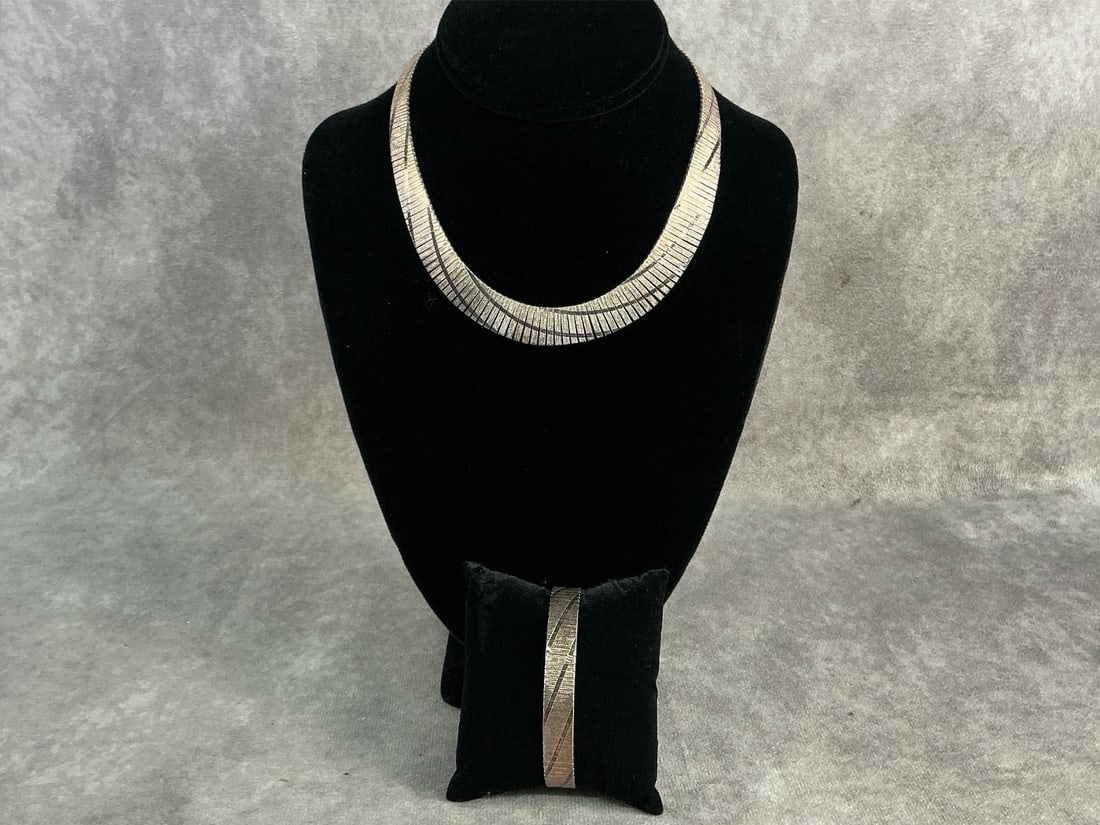 Sterling Necklace & Bracelet: Sterling silver bracelet and necklace with graduated Cleopatra design in a distinct diagonal striped texture. In good condition, stamped with oxidation present. Total weight 1.46 ozt.