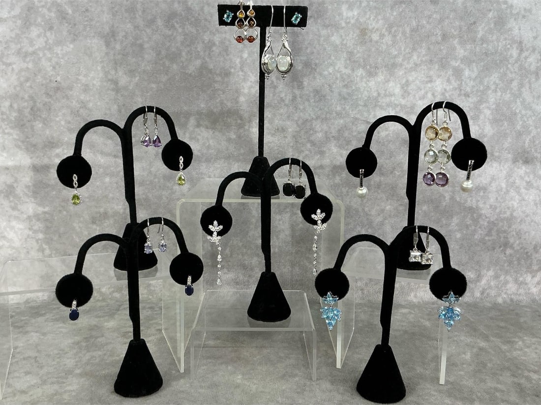 Sterling Silver Earrings: Thirteen sterling silver earrings with a variety of stones and settings. All stamped 925. All in good condition. Total weight 1.63 ozt.