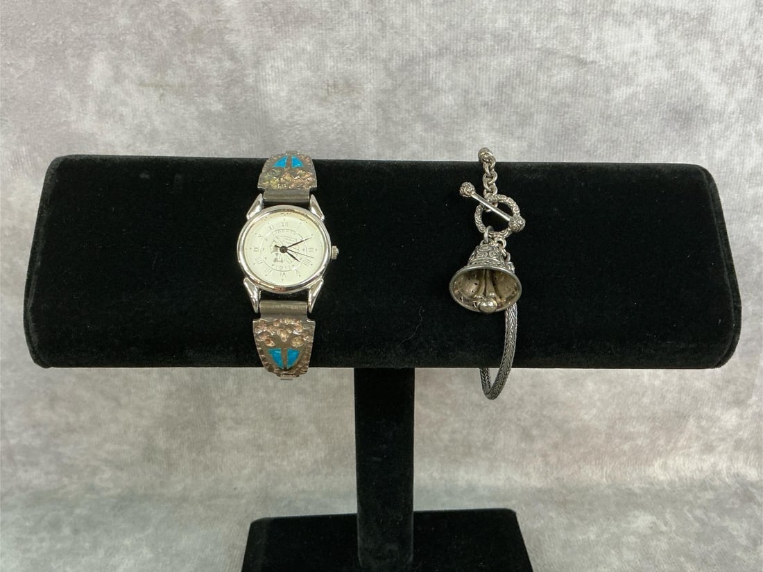 Sterling Silver Watch & Bracelet: Two sterling silver jewelry pieces. Included are a Zander Makarim "Sound of a Bel" bracelet with a toggle clasp and a turquoise inlay watch with an Indian head on the face. Both stamped 925. Watch
