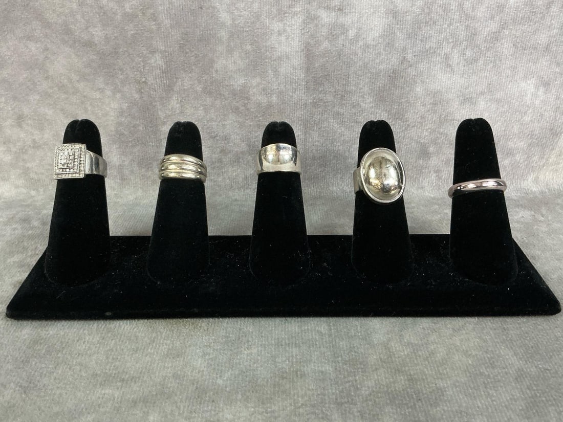 Sterling Silver Rings: Five sterling silver rings with a variety of styles and settings. All stamped 925. All in good condition. Total weight .99 ozt.