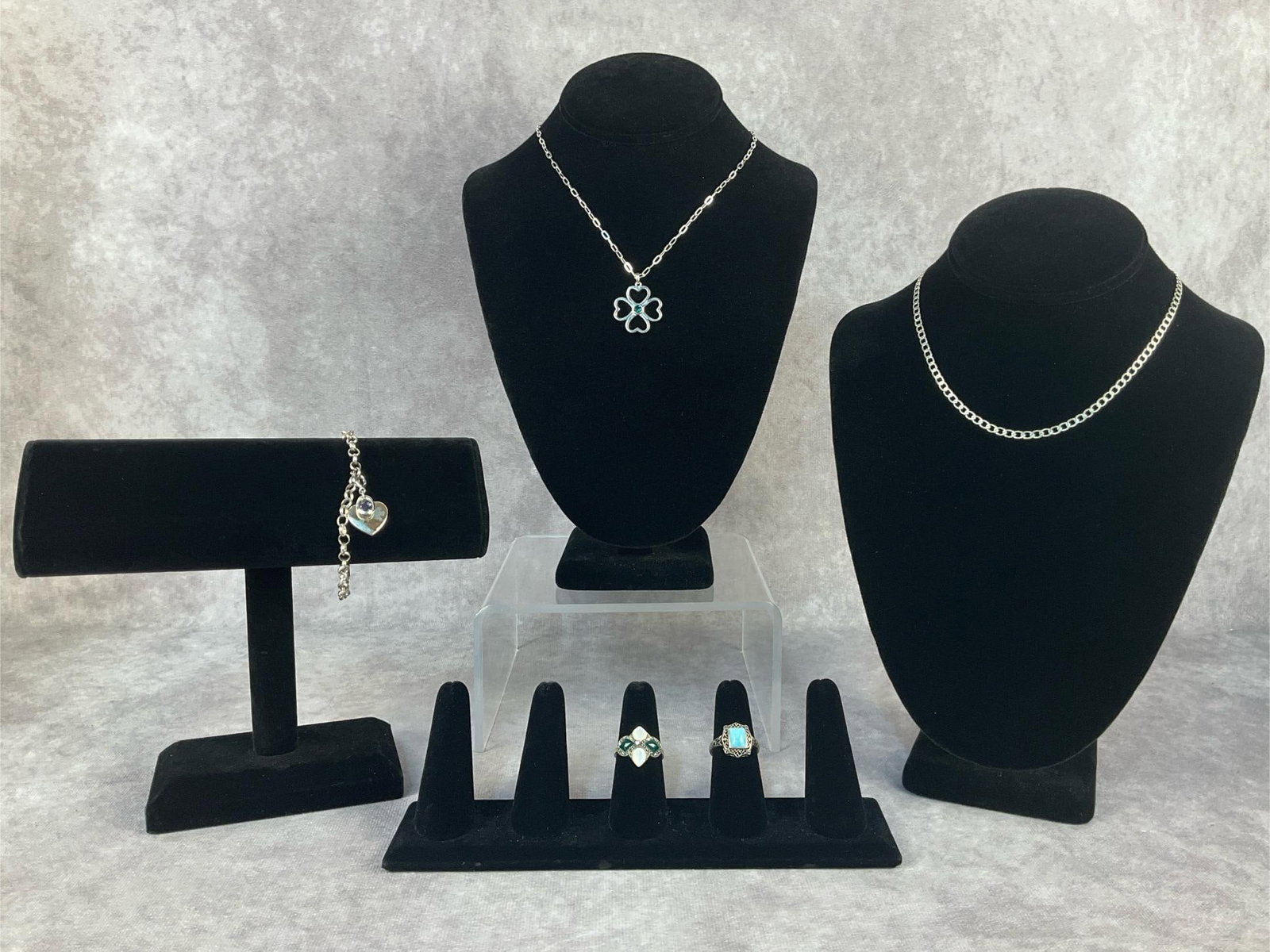 Sterling Silver Jewelry: Five sterling silver jewelry pieces. Lot includes a Talbots Sterling silver necklace with 4 Leaf clover charm a heart charm bracelet, a link necklace and two rings. All in good condition. Total