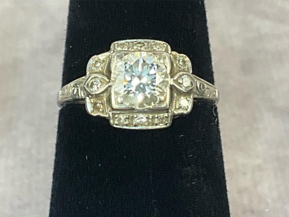 Diamond Solitaire Ring: Rhodium plated over gold diamond ring. Rhodium stamped and diamond tested. Total carat 1 Ct. Women's size six. In good condition. Total weight 1.9 dwt.