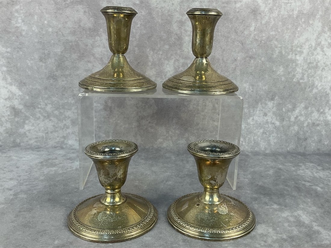 Candle Holders: Four weighted sterling silver candlestick holders. All in good condition. Total weight 2.77 ozt.