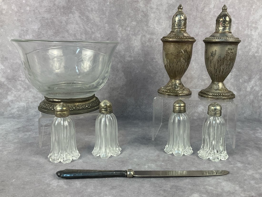 Silver Serving Pieces: Eight vintage sterling silver serving items. Lot includes two glass lined salt and pepper shakers, four cut glass with sterling silver lids, one etched glass divided bowl with sterling silver base