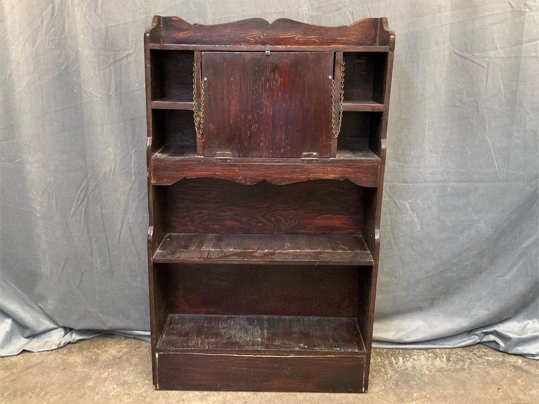 Arts and Crafts Bookcase: Early-mid 20th century Arts and Crafts style pine desk/bookcase with drop down lid. Missing two interior shelves, otherwise good condition. Measures 29 inches wide x 10 x 48 inches tall.