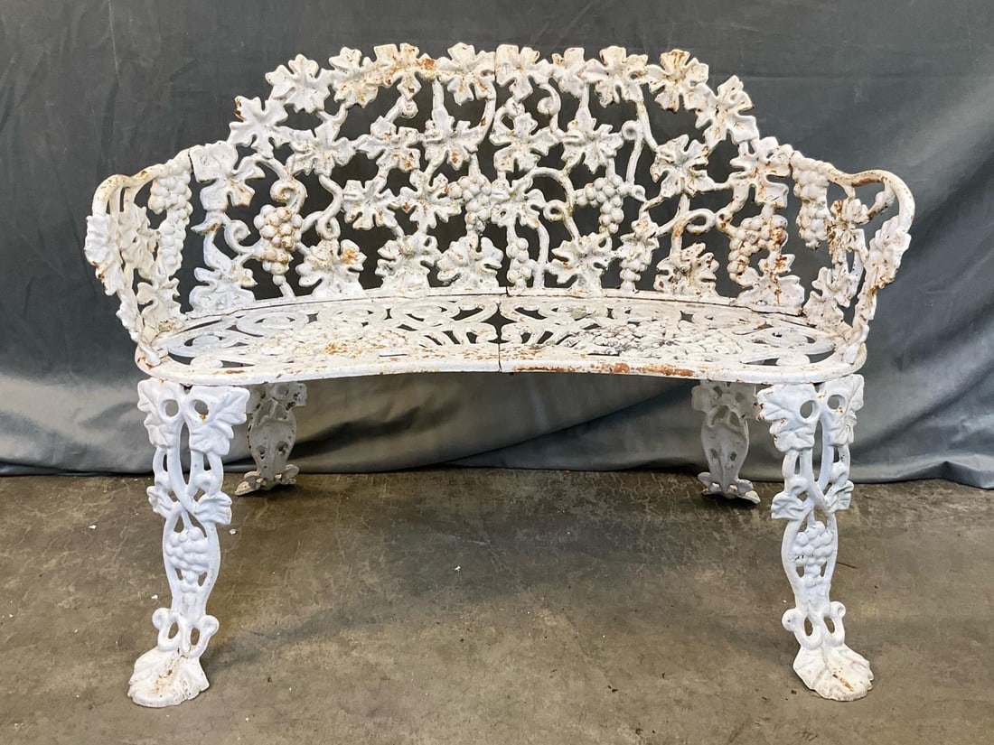 Garden Bench: Early 20th century cast iron Victorian garden bench. Minor areas of surface rust with flaking paint, otherwise good condition. Measures 38.5 inches x 15 x 28 inches tall.