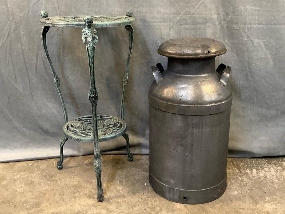 Table and Milk Can: Late 20th century cast iron garden two tiered table with verdigris finish and grey painted milk can. Good used condition. Table measures 15 inches in diameter x 29 inches tall.