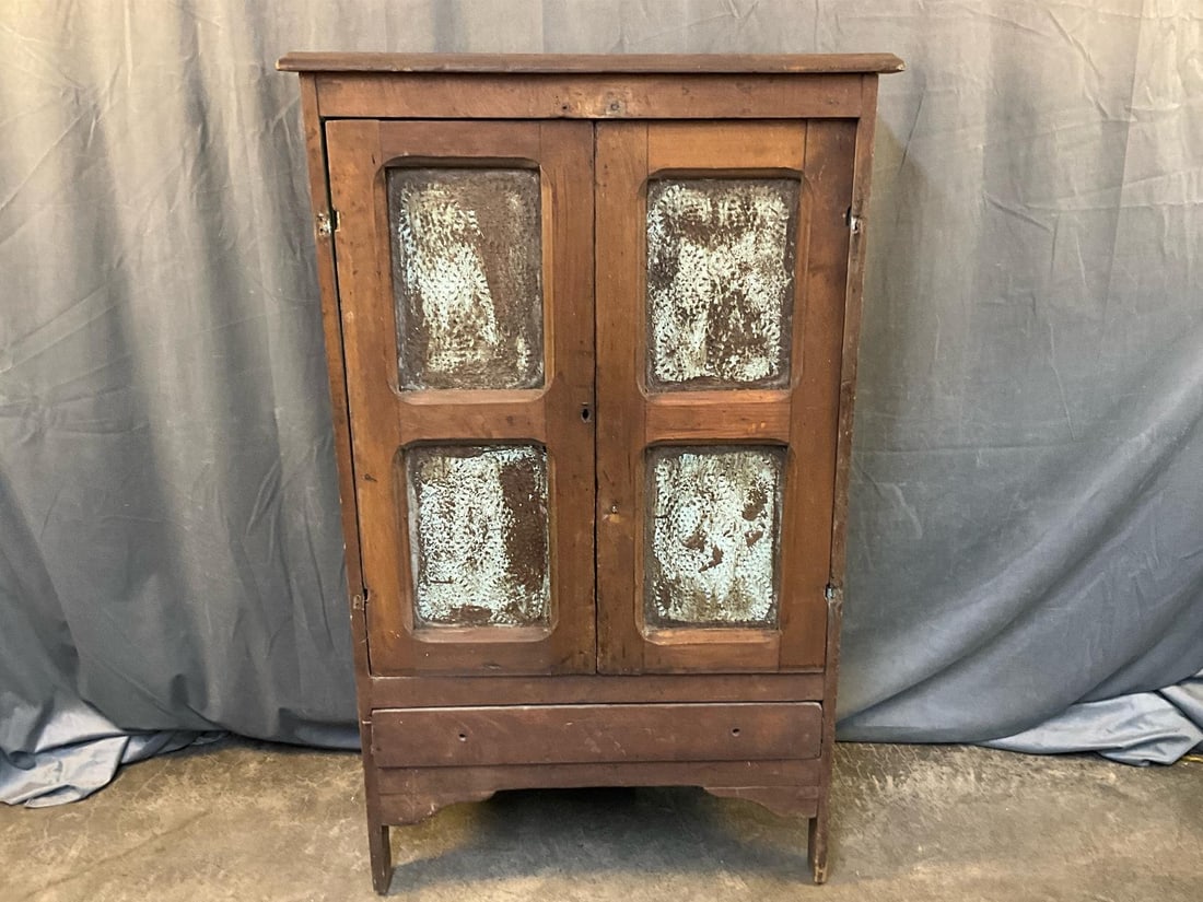 Pie Safe: Circa 1870 poplar and pine pie safe with lower drawer and geometric punched tin paneled doors and sides and painted blue interior. Two doors not mounted, missing drawer pulls and drawer with loose