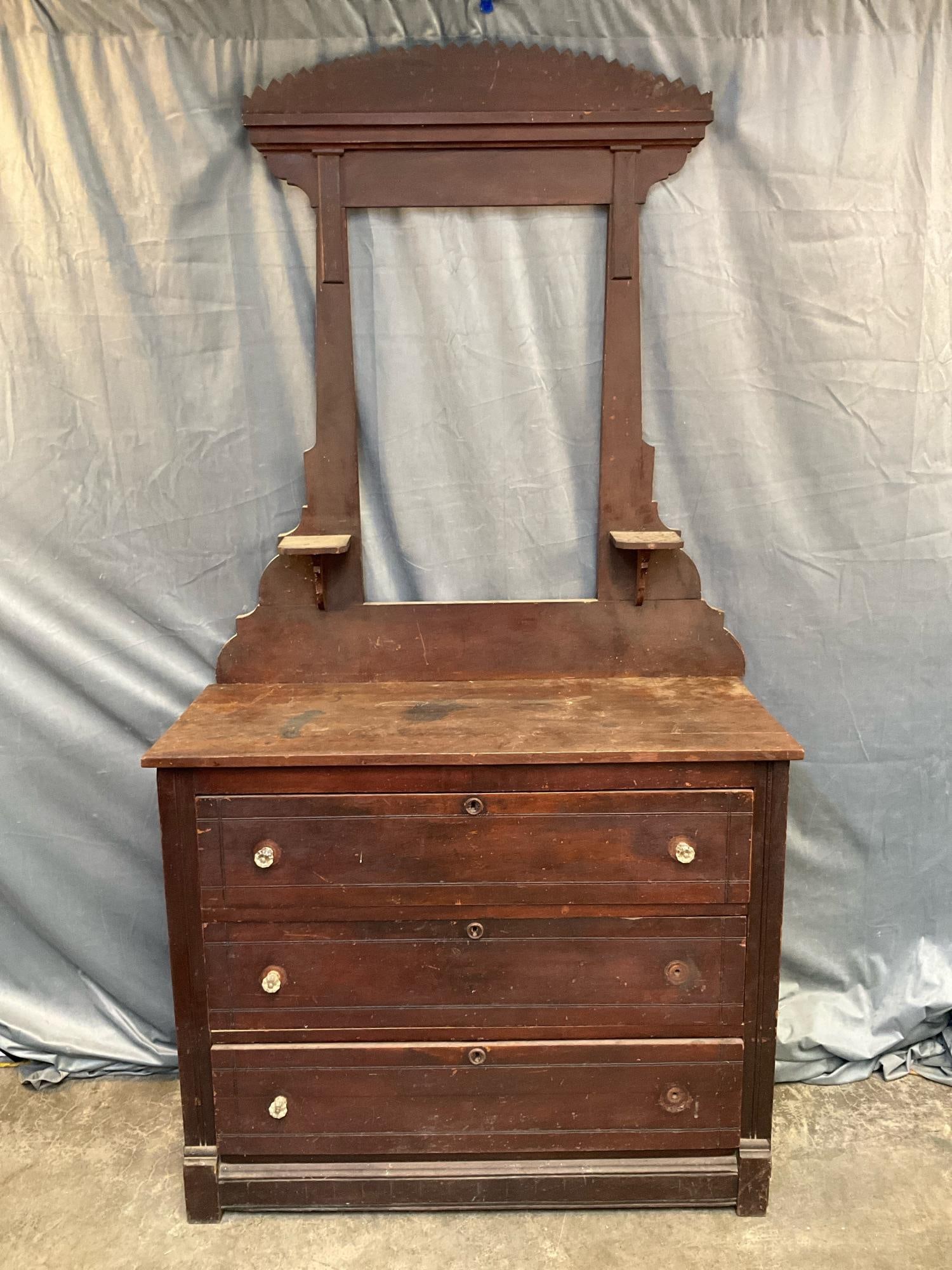 Chest of Drawers: Late 19th century walnut cottage style chest of drawers/dresser. Missing mirror and two glass pulls with stains to top finish and replaced pulls. Measures 42.25 inches wide x 18.5 x 34 inches tall.