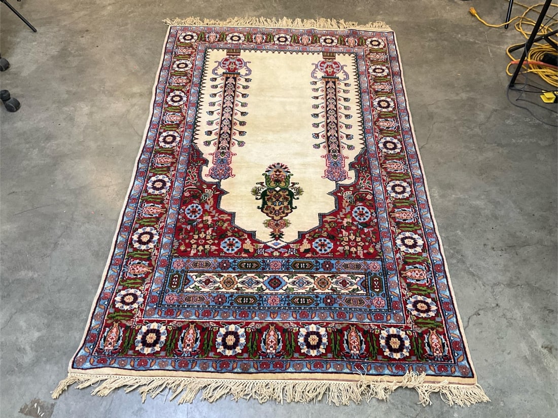 Oriental Rug: Late 20th century oriental prayer rug made in India. Small area of red color bleeding into the adjacent cream area, otherwise good condition. Measures 4 ft. X 6 ft..