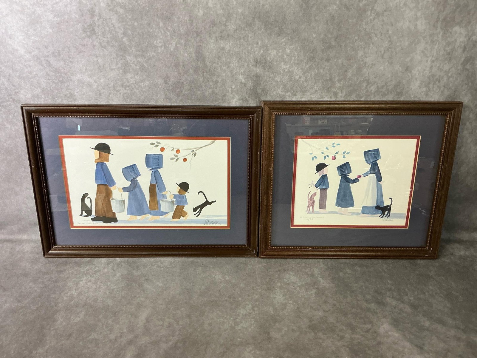 Diane Graebner Black Cat Prints: Two signed 1990 and 1993 Diane Graebner prints "Helpin' Mom and Dad" number 298/750 and "An Apple for the Teacher" number 197/750. Some dings to wood frames, otherwise good condition. Largest