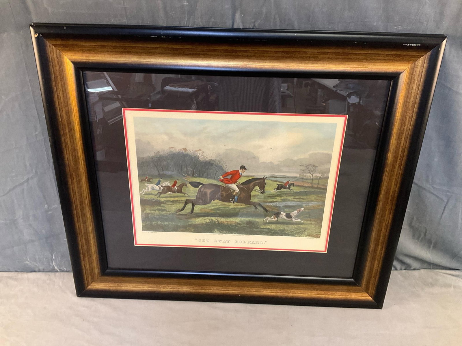 Hunting Print: Late 20th century modern reproduction English hand coloured framed and matted fox hunting print. Good condition. Measures 38 inches wide x 1.5 x 32 inches tall.