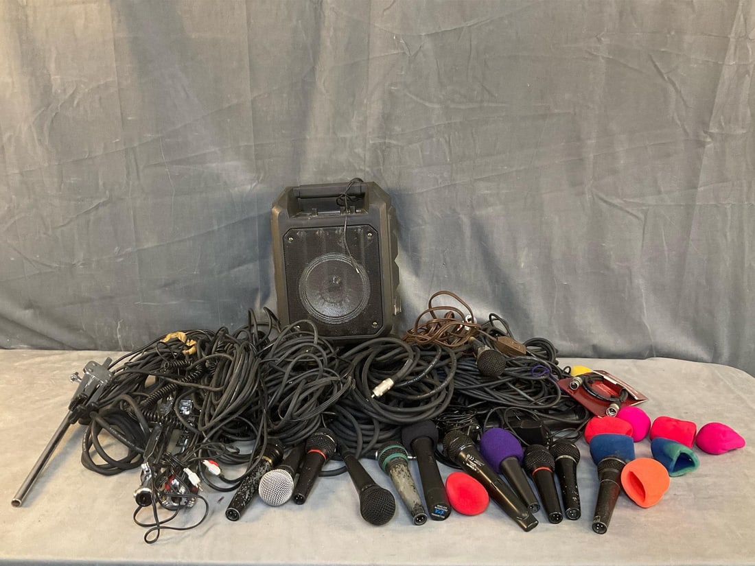 Microphones and Cords: Approximately twelve microphones and cords, three stands, electronic jack plugs, and one portable microphone speaker amp. Not tested. Used condition. Speaker measures 10.5 inches wide x 7 x 14 inches
