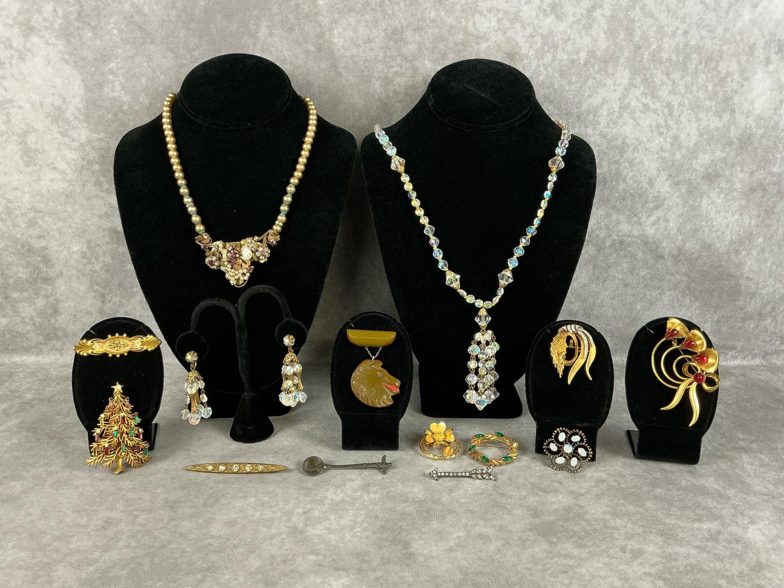 Early Costume Jewelry: Fourteen pieces of early costume jewelry pieces. Includes a sterling totem pole spoon brooch, and a sterling rhinestone arrow brooch. The Hayward gold brooch is 1/20 12kt gold filled. Glass bead neckl