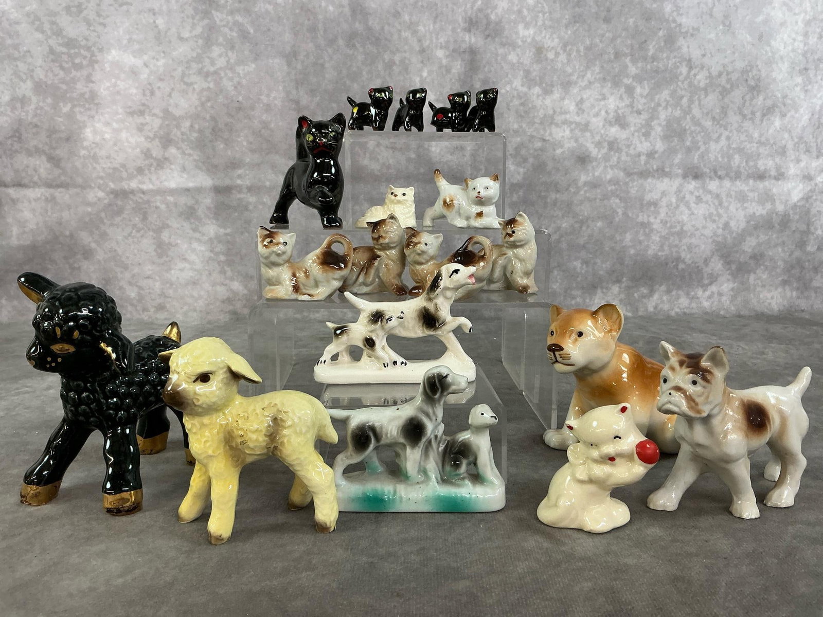 Ceramic Animal Collection: Eighteen mid to late 1900's collection of cats, lambs, dogs, and lion cub. Includes Hagen-Renaker, Shawnee Pottery black lamb, Goebel yellow lamb, Royal Dux lion cub, and more. Small black cat with