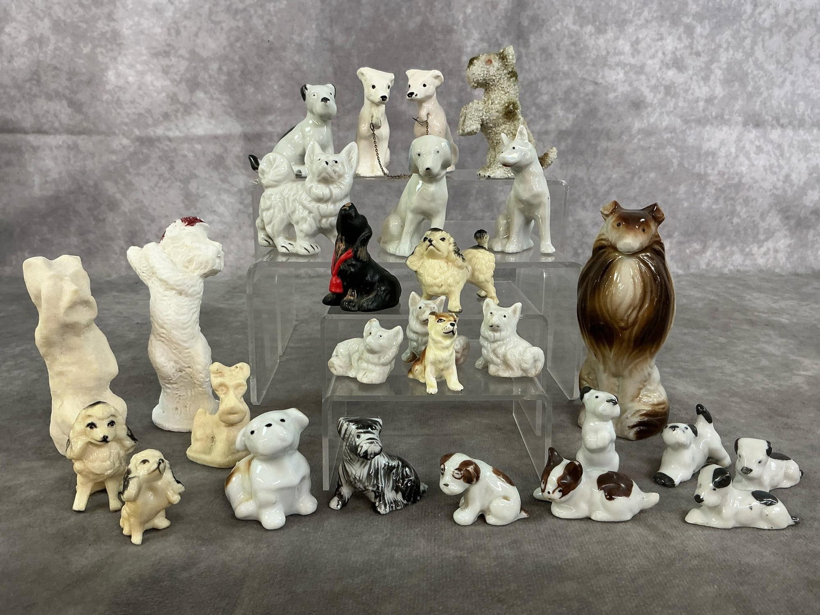 Miniature Dogs: Twenty-seven mid to late 1900's miniature dog collection. Includes ceramic, plaster, and plastic. Terriers, collie, poodles, beagles, Pomeranian, and more. In good condition. Collie measures 1.5