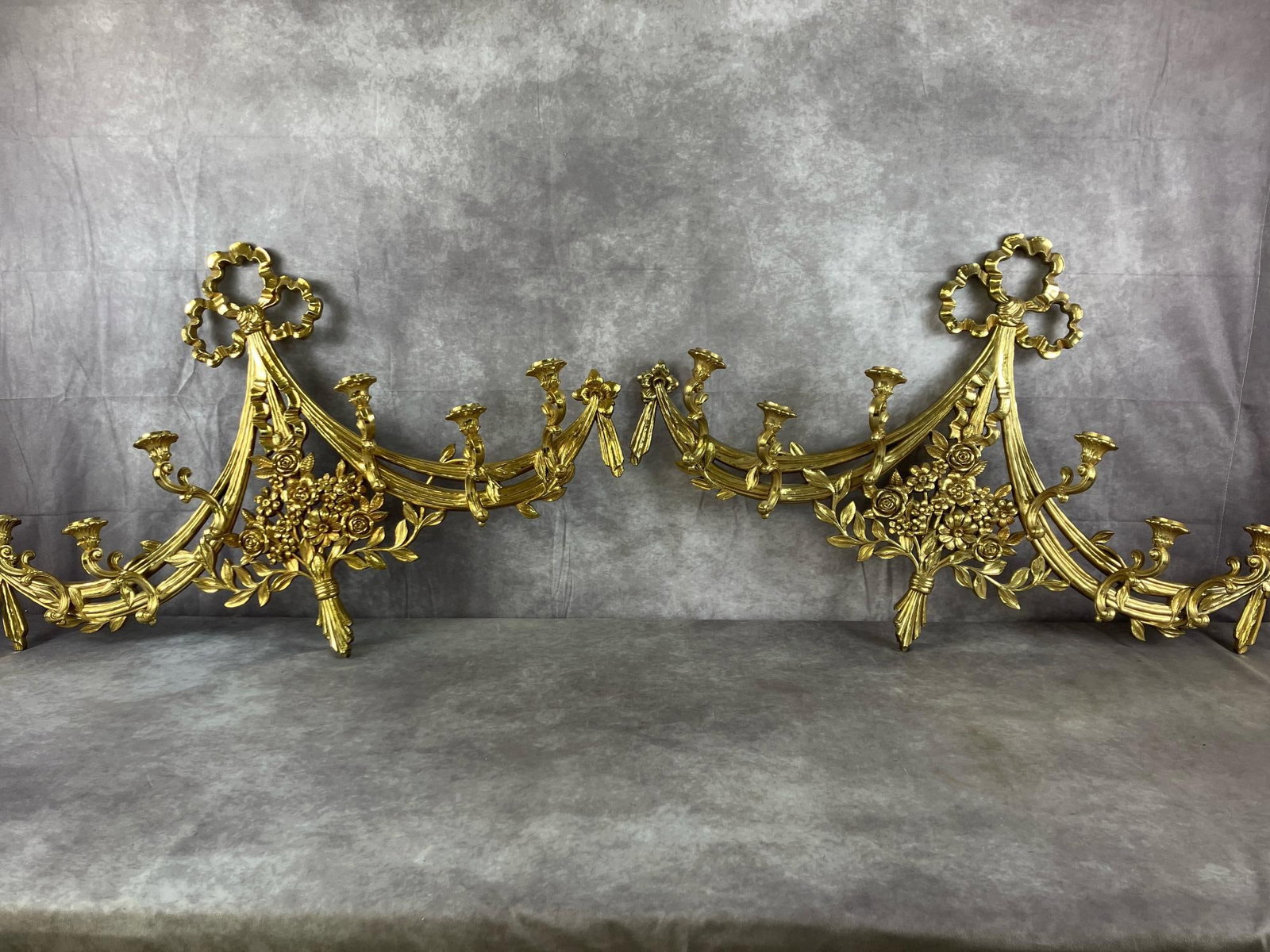 Large Gilt Sconce Set: Two late 1900's molded resin gold gilt sconces. Hollywood regency candlebra with six holders each. In good condition. Each measures 39 inches long x 4 x 25 inches tall.
