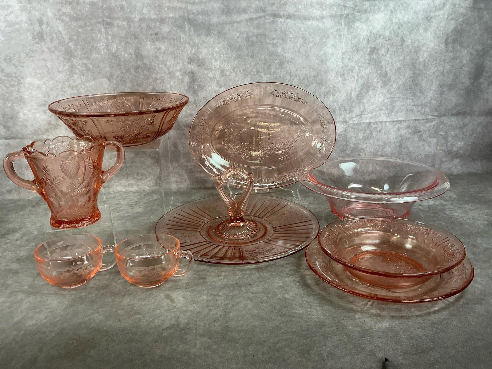 Pink Depression Glass: Nine early 1900's pink Depression glass. Includes Cabbage Rose platter, bowl, small bowl and plate. (Small nick on edge of larger bowl). Also, Fenton strawberry celery vase, Mayfair handled serving
