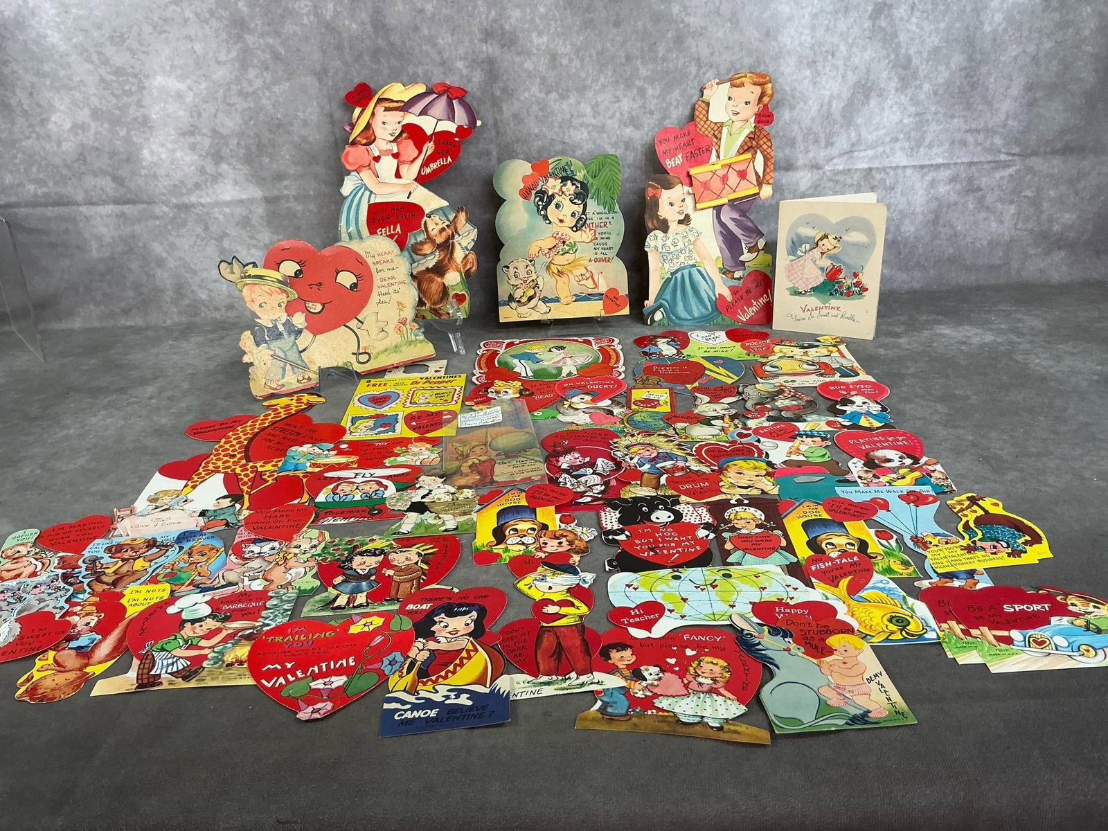 Vintage Valentines: Over fifty 1930's to 1960's Valentines. Includes World's Fair Valentine and large cards. Most have writing on back. Some age related wear, otherwise in good condition. Largest measures 5 inches wide