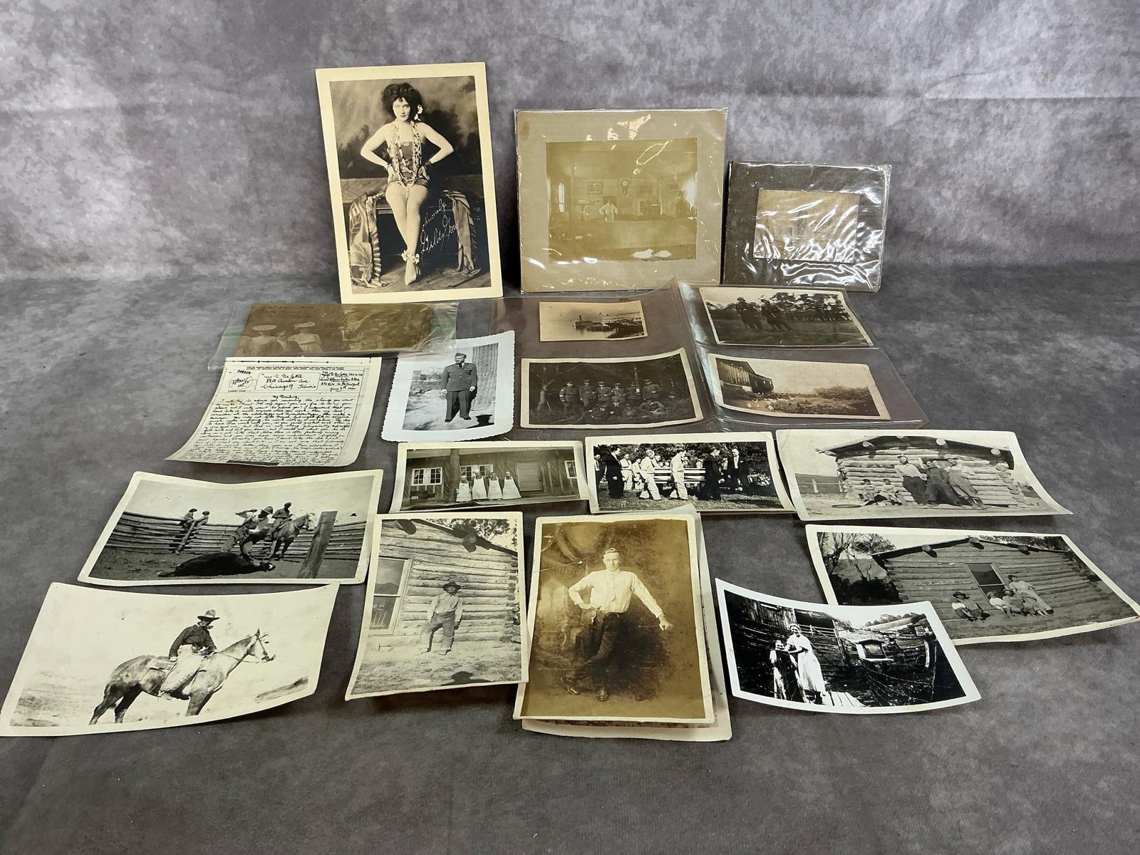 Vintage Photographs of Cowboys, Soldiers, & More: Twenty-two early to mid 1900's black and white photographs. Includes cattle branding, farm pictures, German and American soldiers, funerals, pin up girls, and more. Some photos are very faded. "Gilda