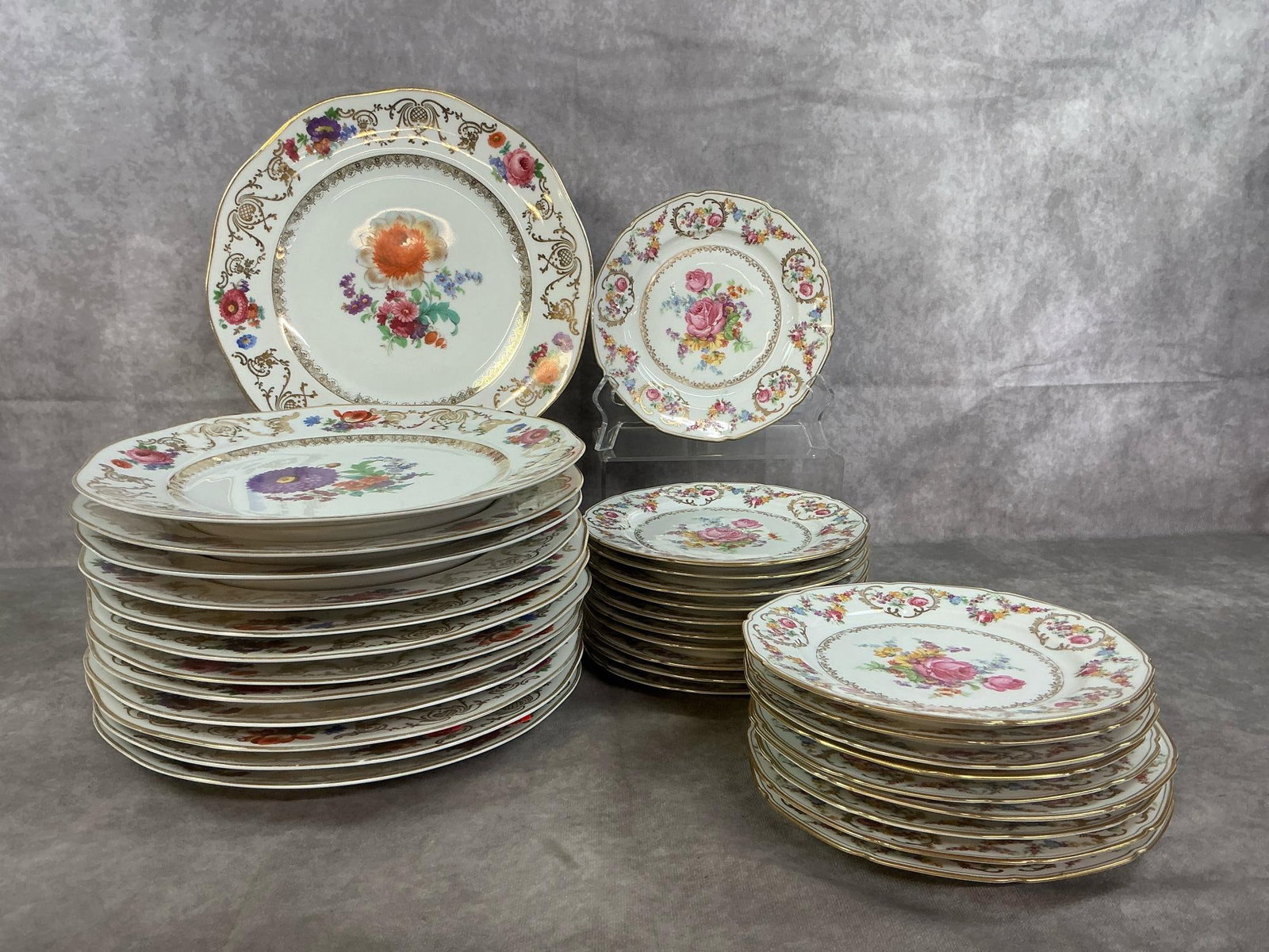 Czeckoslovakian China Plates: Thirty-three vintage floral dinner plates and salad plates. Eleven inch dinner plates by ER Phila and seven inch Imperial Rose salad plates by Baronet, both Czechoslovakian companies. Plates have