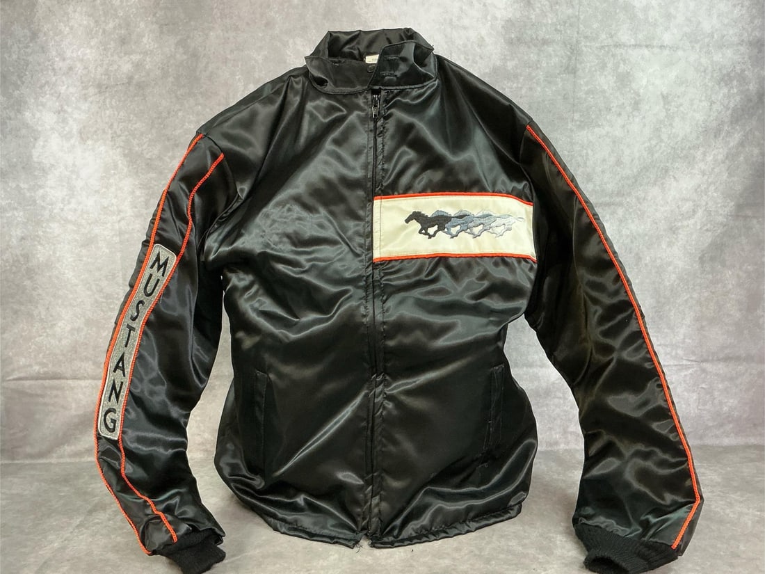 Vintage Mustang Jacket: 1979 size large jacket by Horizon. 500 Pace Car Mustang satin jacket with shiny nylon shell and orange trim. Zipper front. In good condition. Measures 18 inches across chest x 24 inches from shoulder