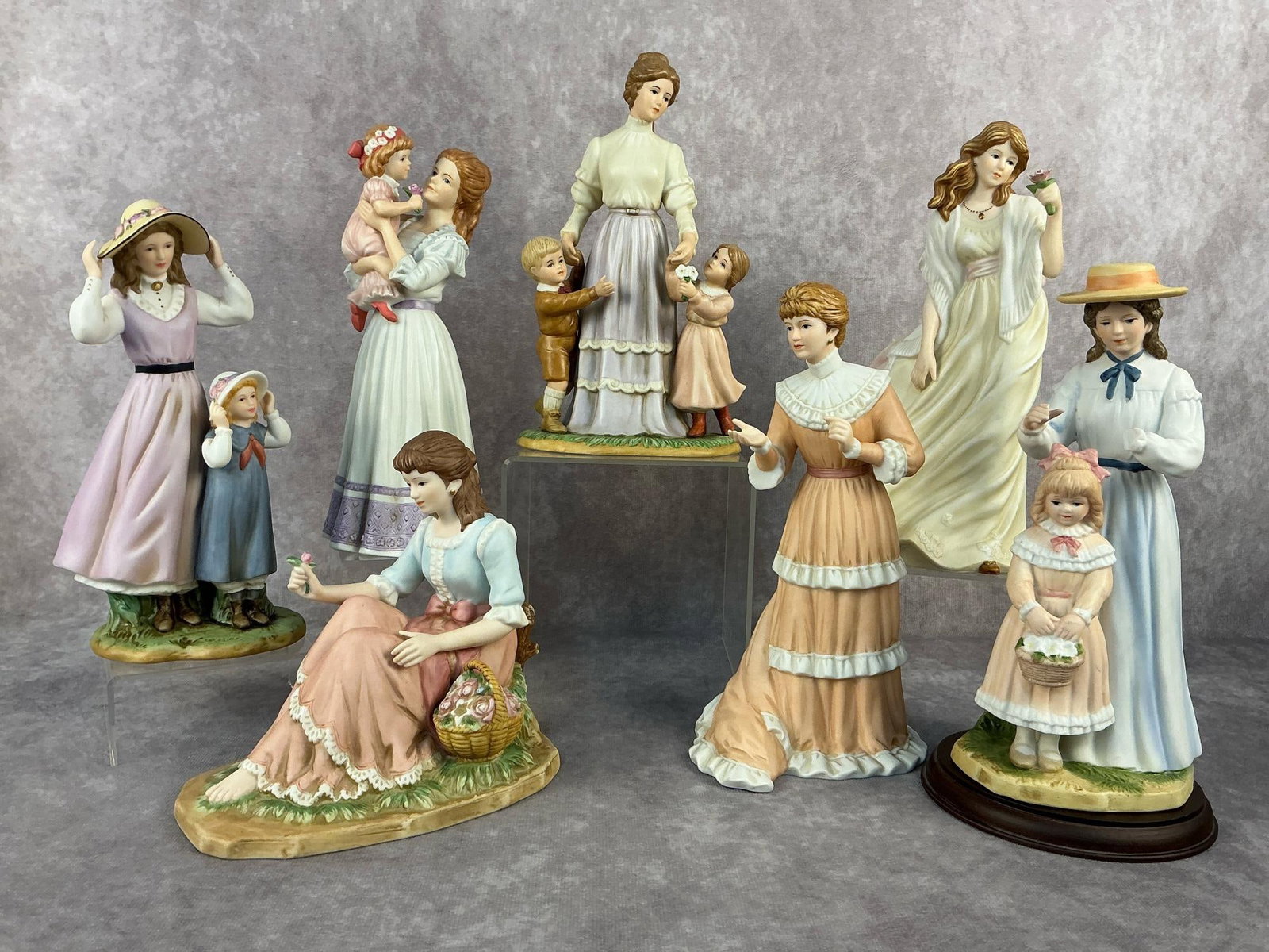 Ladies & Children Figurines: Seven 1998 - 2003 collectible Home Interiors / Homco Figurines. Mother in blue dress with daughter holding basket has one hand broken off and one hand chipped, otherwise all in good condition.