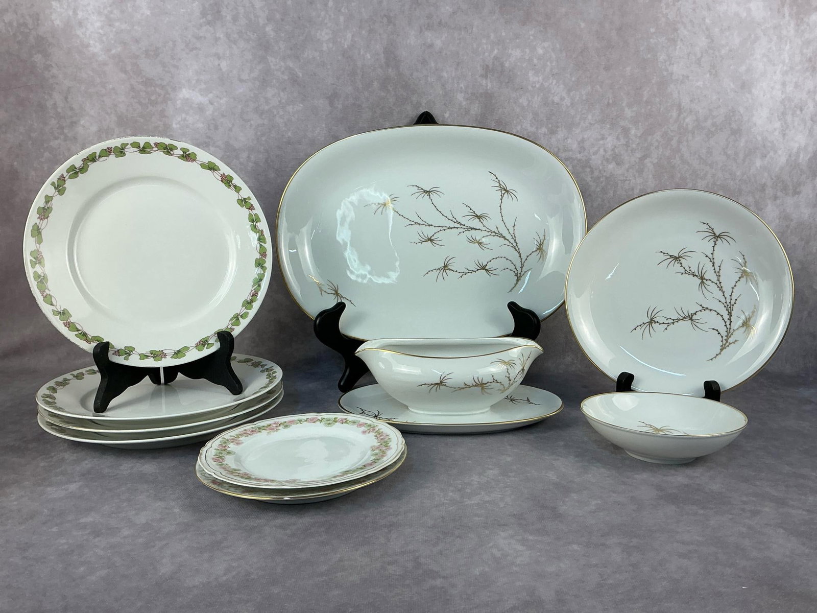 Limoges China & More: Ten vintage fine china pieces. Lot includes four Rosenthal Golden-Palm dishes, a large platter, an appetizer plate, gravy boat with attached underplate and a fruit bowl. Four Limoges salad plates,