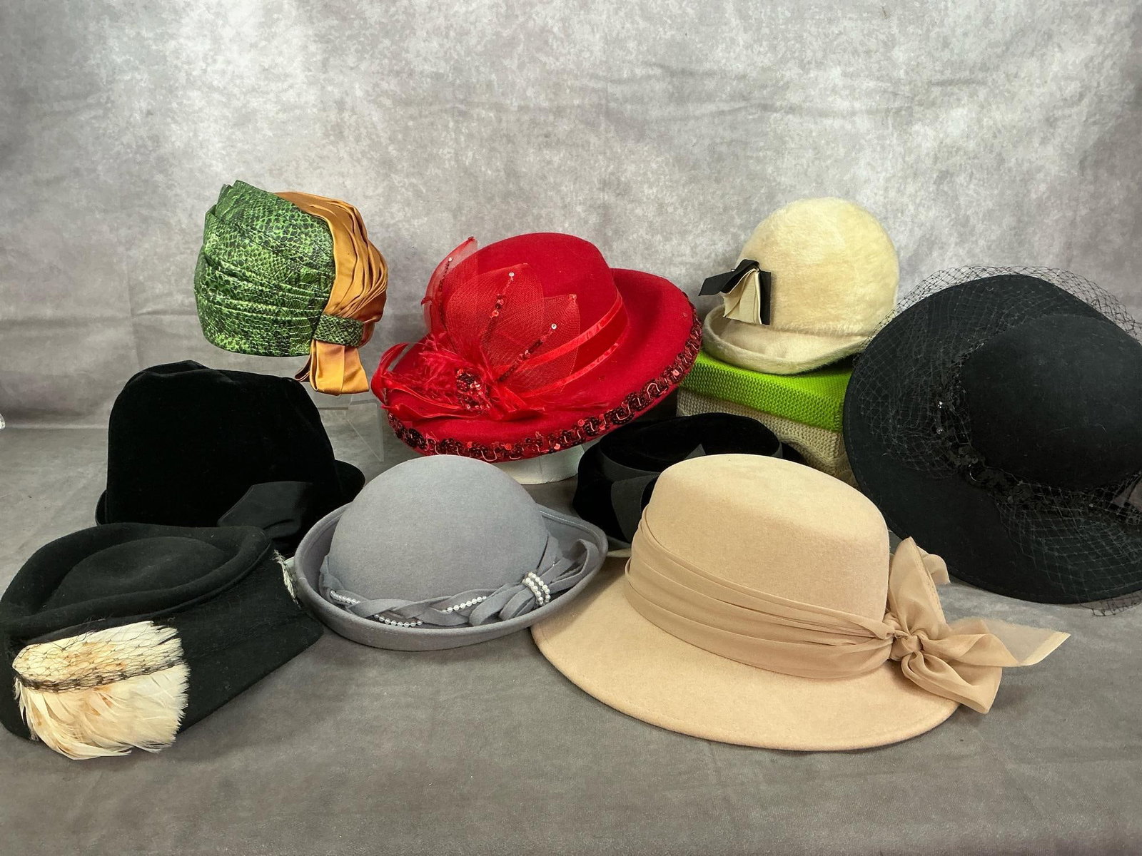 Vintage Formal Hats: Nine mid to late 1900's ladies hats. Assortment of colors and styles. Velvet, felt, and vinyl. Some age related wear, otherwise in good condition. Red hat measures 14 inches in diameter x 8.5 inches